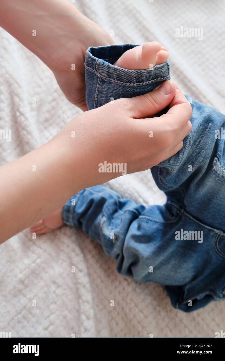 Boy putting on pants hires stock photography and images Alamy