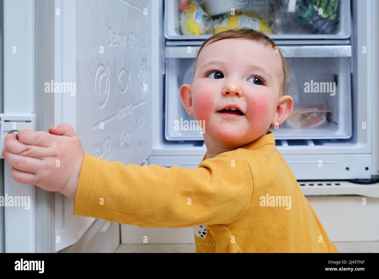Toddler baby boy with allergies on red cheeks climbed into an open