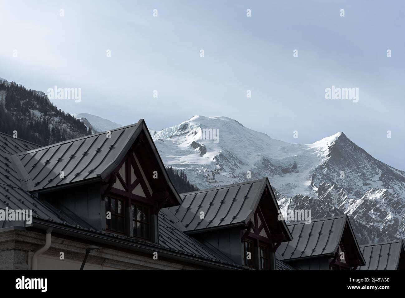 Close-up detail of railway rooftop dormers in front of the Mont Blanc mountain range and Dôme du Gouter in Chamonix France Stock Photo