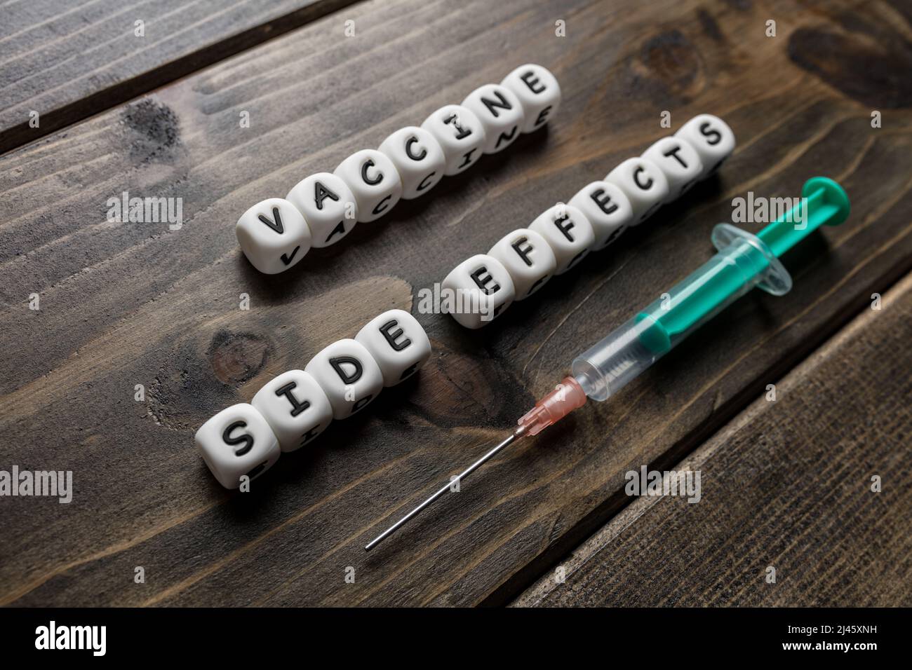 Corona virus Covid-19 vaccine text on wooden background Stock Photo