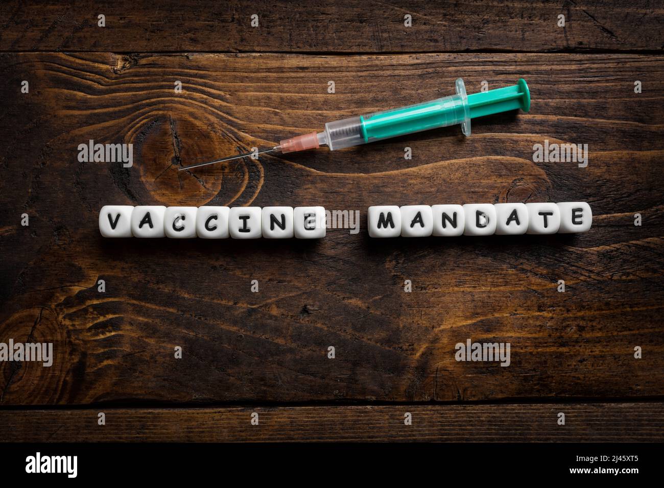 Corona virus Covid-19 vaccine text on wooden background Stock Photo