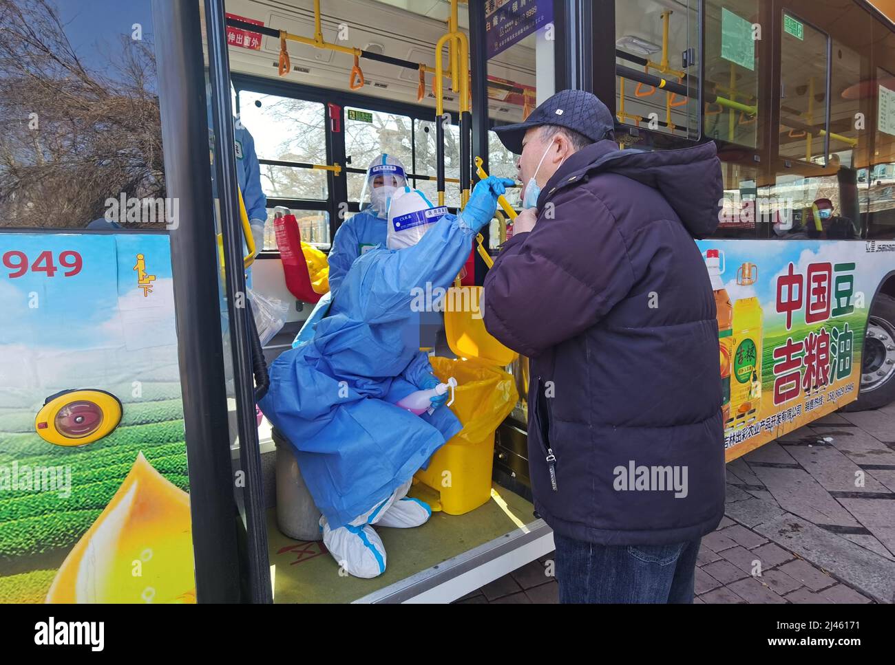 CHANGCHUN, CHINA - APRIL 12, 2022 - A medical worker performs nucleic acid tests on a bus in Changchun, Northeast China's Jilin Province, April 12, 20 Stock Photo