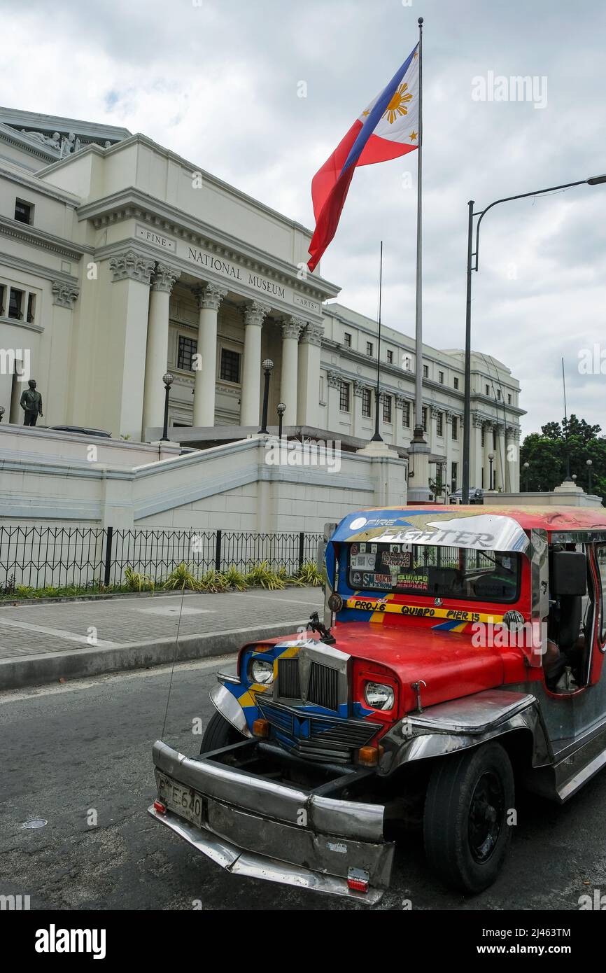 Manila, Philippines - March 2022: A jeepney driving past the National Museum of Fine Arts on March 27, 2022 in Manila, Philippines. Stock Photo