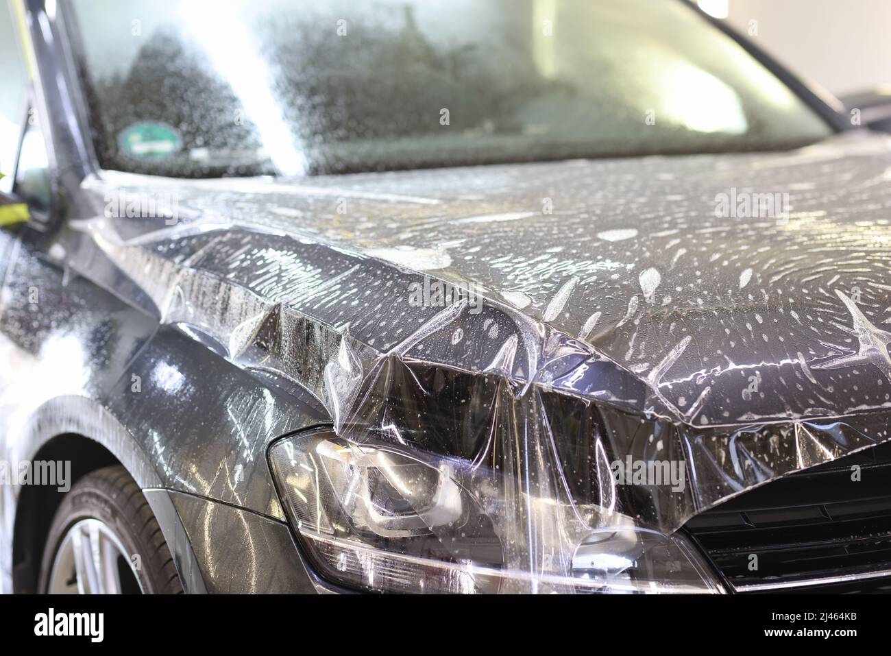 Car wrapping transparent vinyl film. Protection of the car hood from stone chips Stock Photo