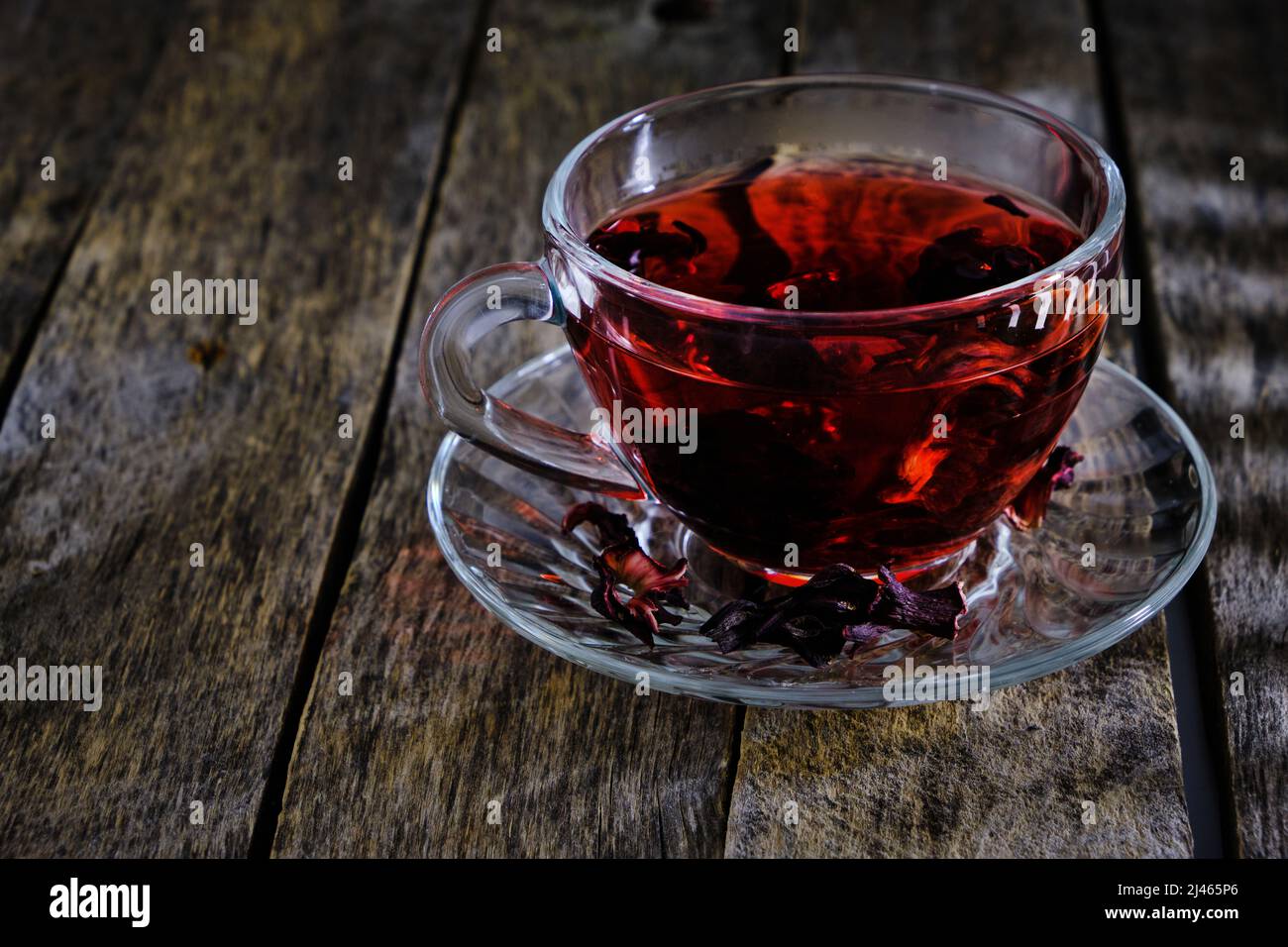 Cup karkade tea with bright red shade wooden background Stock Photo