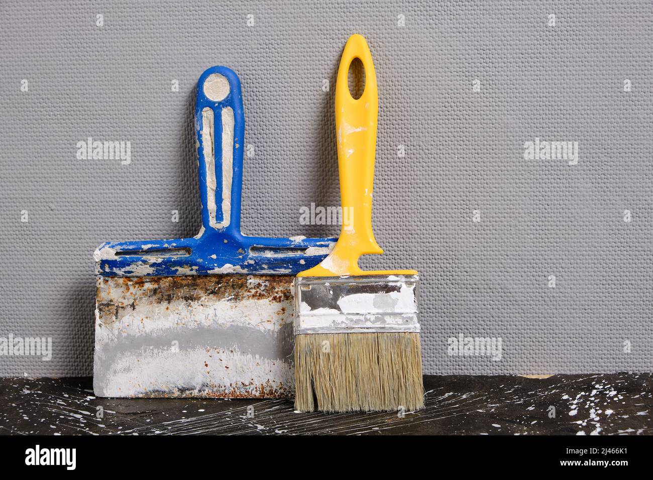 Spatula for finishing and plastering walls and paint brush gray wall