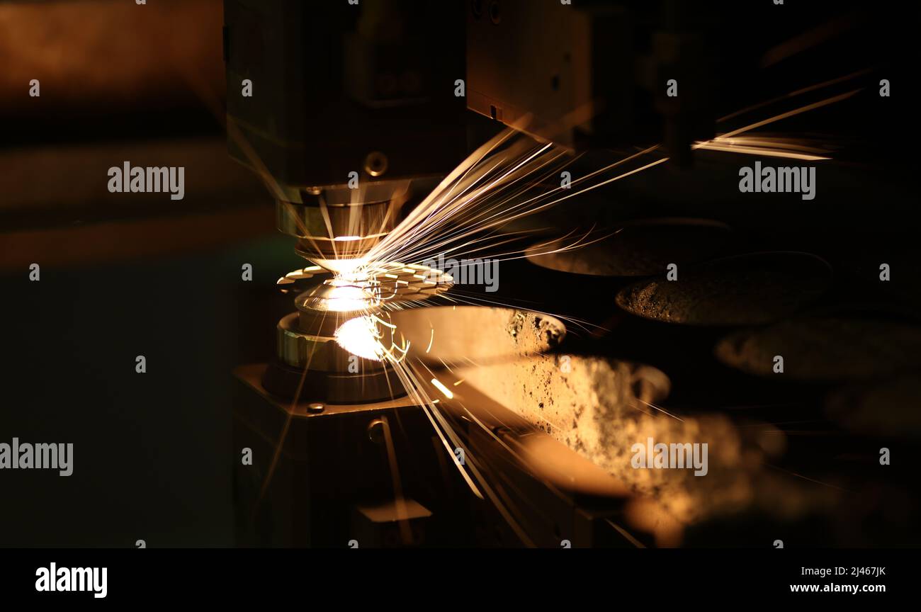 Laser cutting technology flat sheet metal steel material processing with sparks Stock Photo