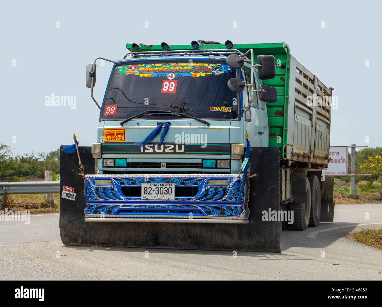 SAMUT PRAKAN, THAILAND, MARCH 23 2022, A truck with wide mud flaps drives on the rural road Stock Photo