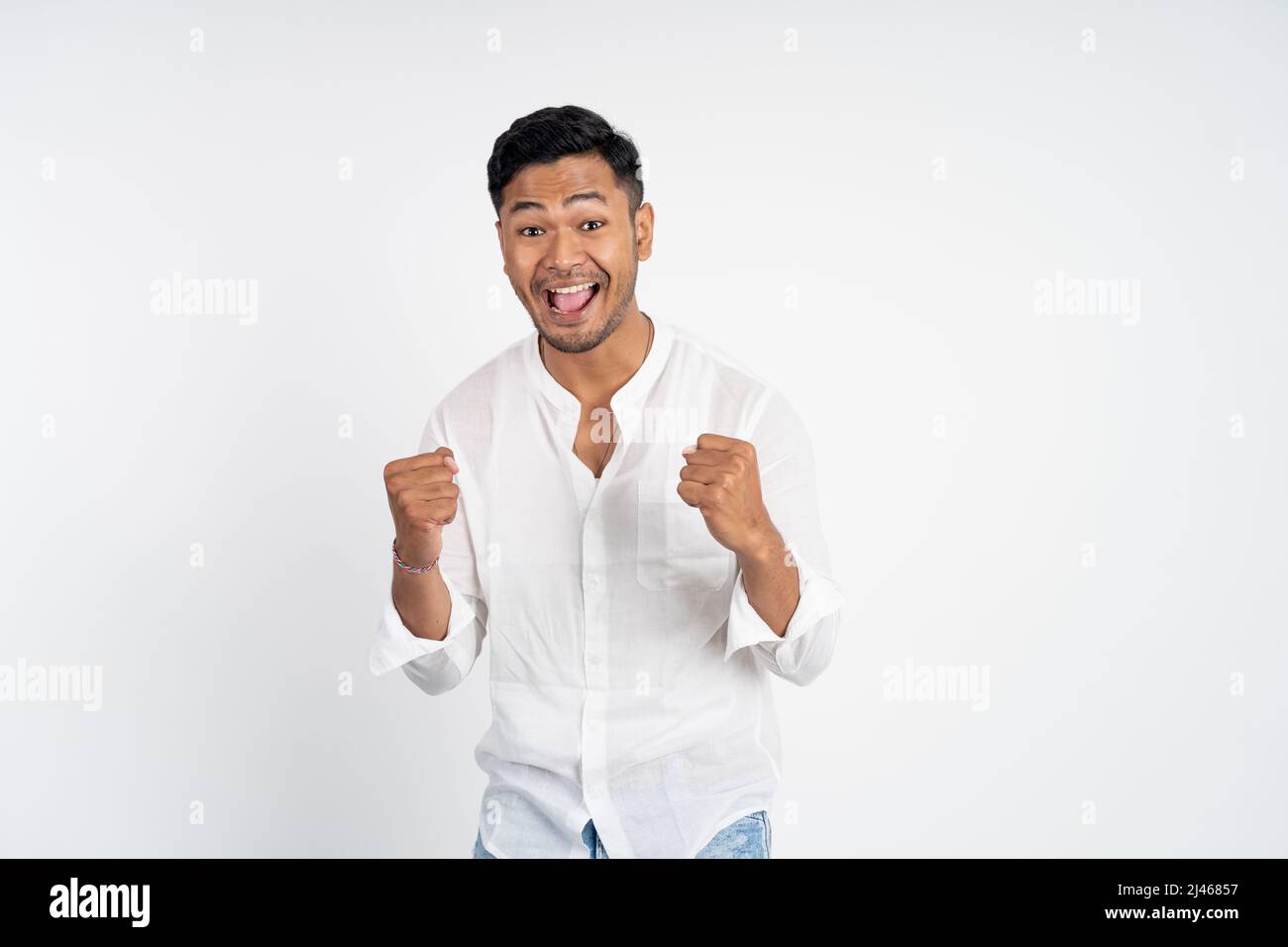 excited young asian man with two hands clenched Stock Photo - Alamy