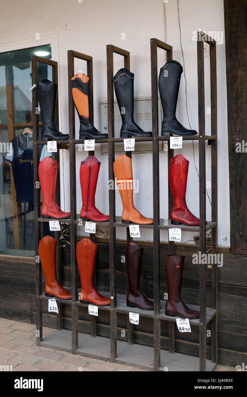 Riding boots outside an equestrian shop in El Rocio, Andalucia, Spain. The town is famous for its pilgrimage and horse riders Stock Photo