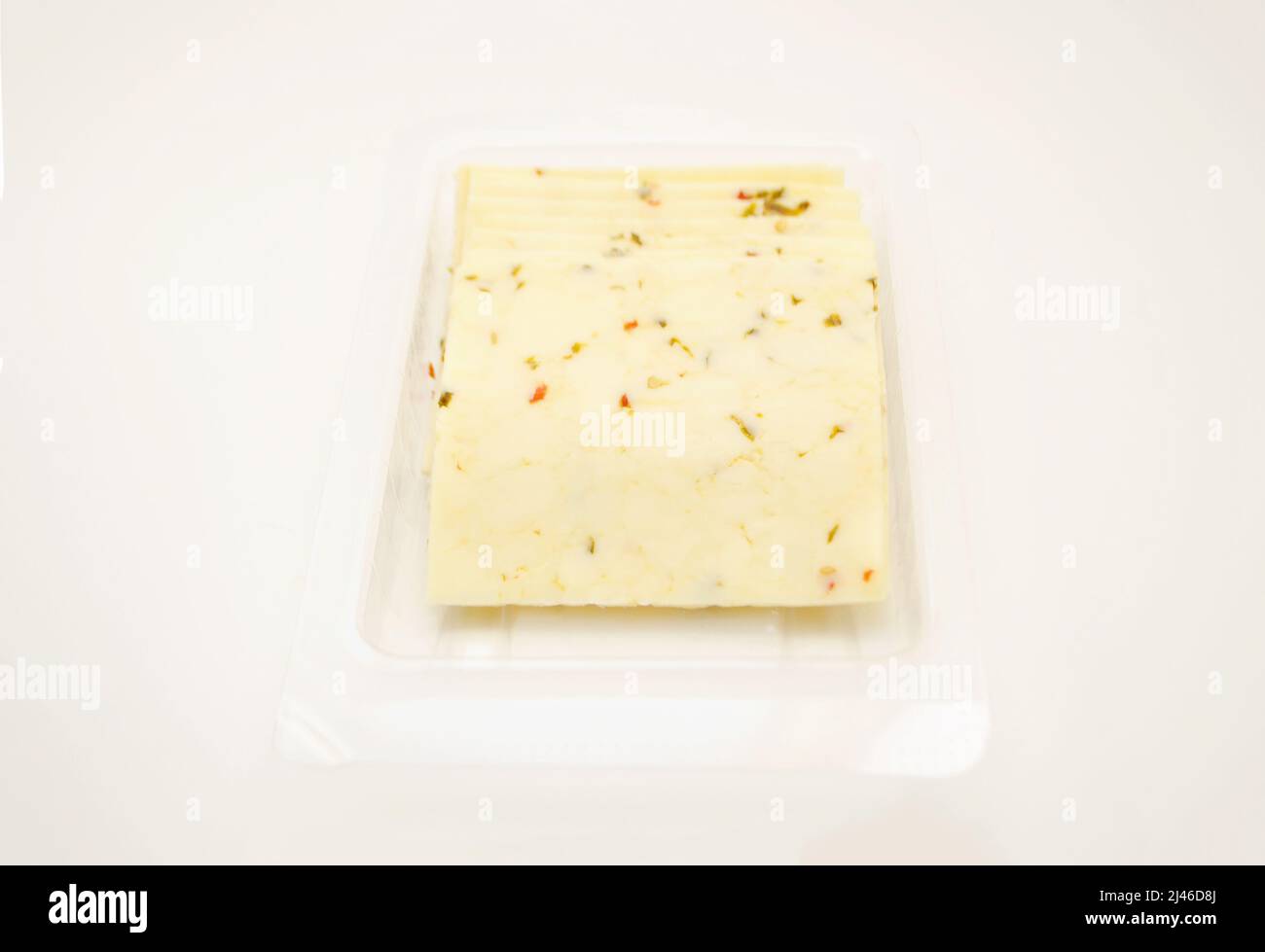 Pepper Jack Cheese Slices Isolated Over a White Background Stock Photo