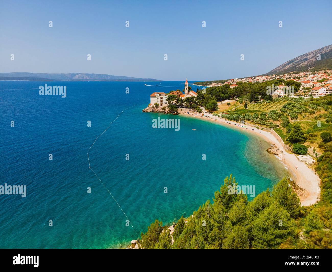 Croatia, Brac island, Bol. Aerial view of pebble beach and Dominician monastery on Adriatic sea. Summer vacation resort Stock Photo