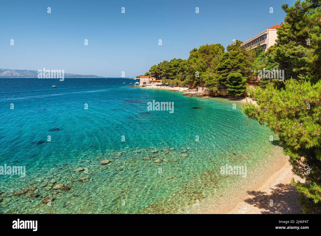 Croatia, Brac island, Bol. Beautiful view of pebble beach on Adriatic sea with small restaurant. Summer vacation resort Stock Photo