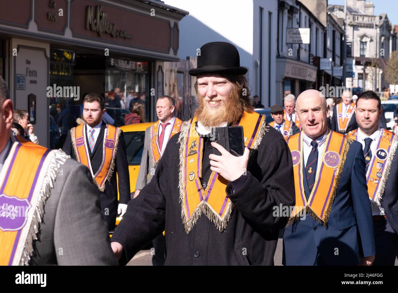 Annual Orange Order parade in Ballymena Co. Antrim celebrating St. Patrick's Day. Orangemen / Orange Lodge members pictured in Church Street Stock Photo
