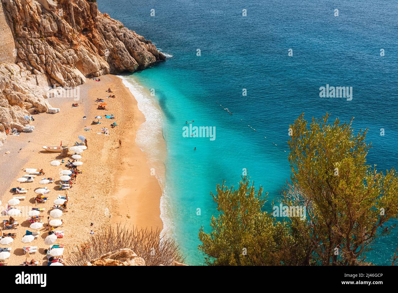 Kaputas sandy beach with blue water on the coast of Antalya region in Turkey with sun umbrellas on the beach. Travel destination Stock Photo