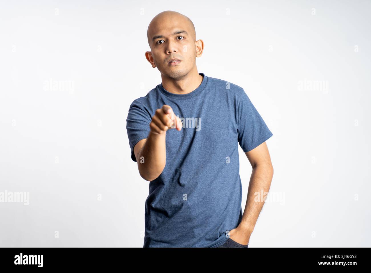 angry asian bald man with finger pointing forward Stock Photo