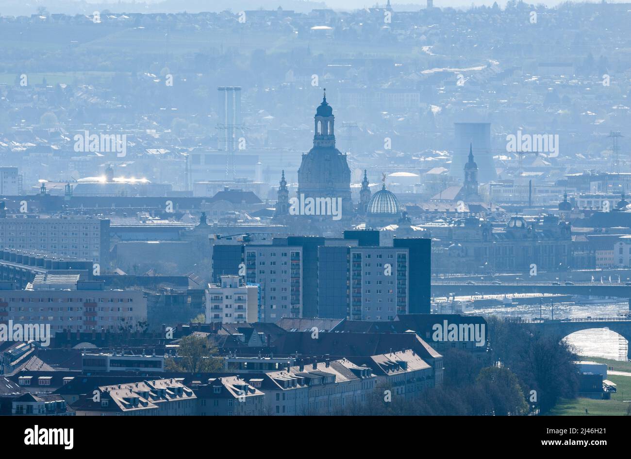 Dresden, Germany. 12th Apr, 2022. View of the city center on the Elbe with the Frauenkirche and the dome of the Kunstakedmie with the angel 'Fama', in the foreground the high-rise buildings in the Johannstadt district can be seen, in the background the chimneys of the Nossener Brücke gas turbine combined heat and power plant. Credit: Robert Michael/dpa/ZB/dpa/Alamy Live News Stock Photo