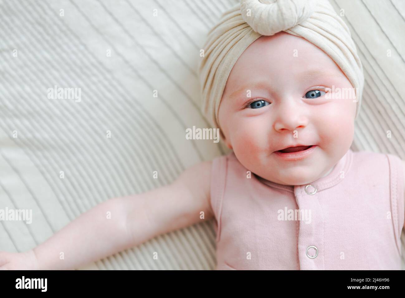 caucasian blue eyed baby girl laying on her back Stock Photo