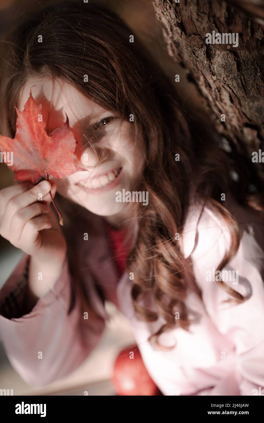 Portrait of a smiling girl in the park with autumn leaves Stock Photo ...