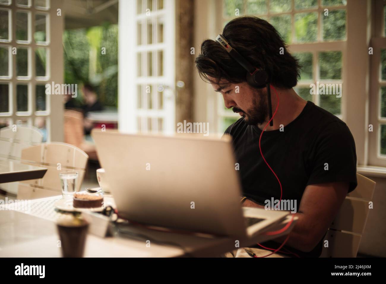 Man working with his notebook on a cafe Stock Photo