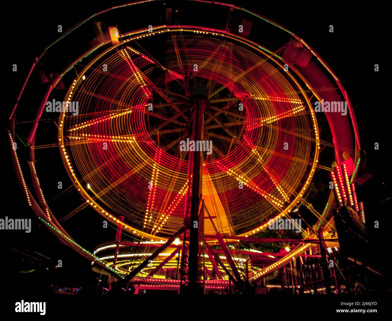 Fairground ride light trails from the annual travelling street fun fair in St Giles, Oxford. Stock Photo