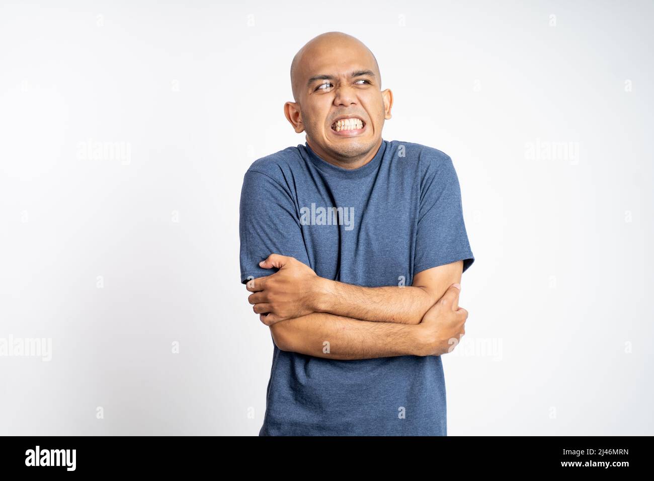 asian bald man sick with fever feeling cold while standing Stock Photo