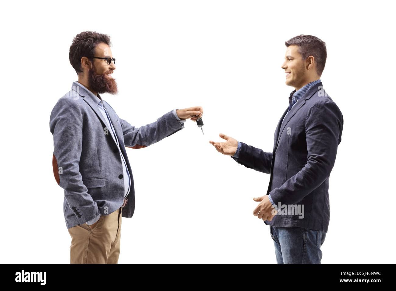 Bearded man giving car keys to a young man isolated on white background Stock Photo