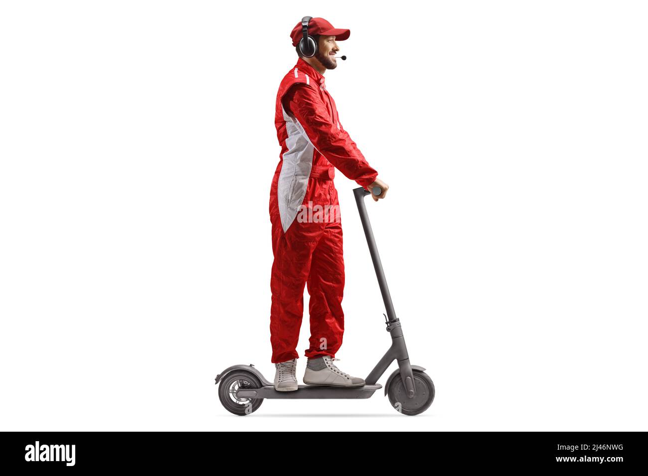 Full length profile shot of a race team member riding an electric scooter isolated on white background Stock Photo