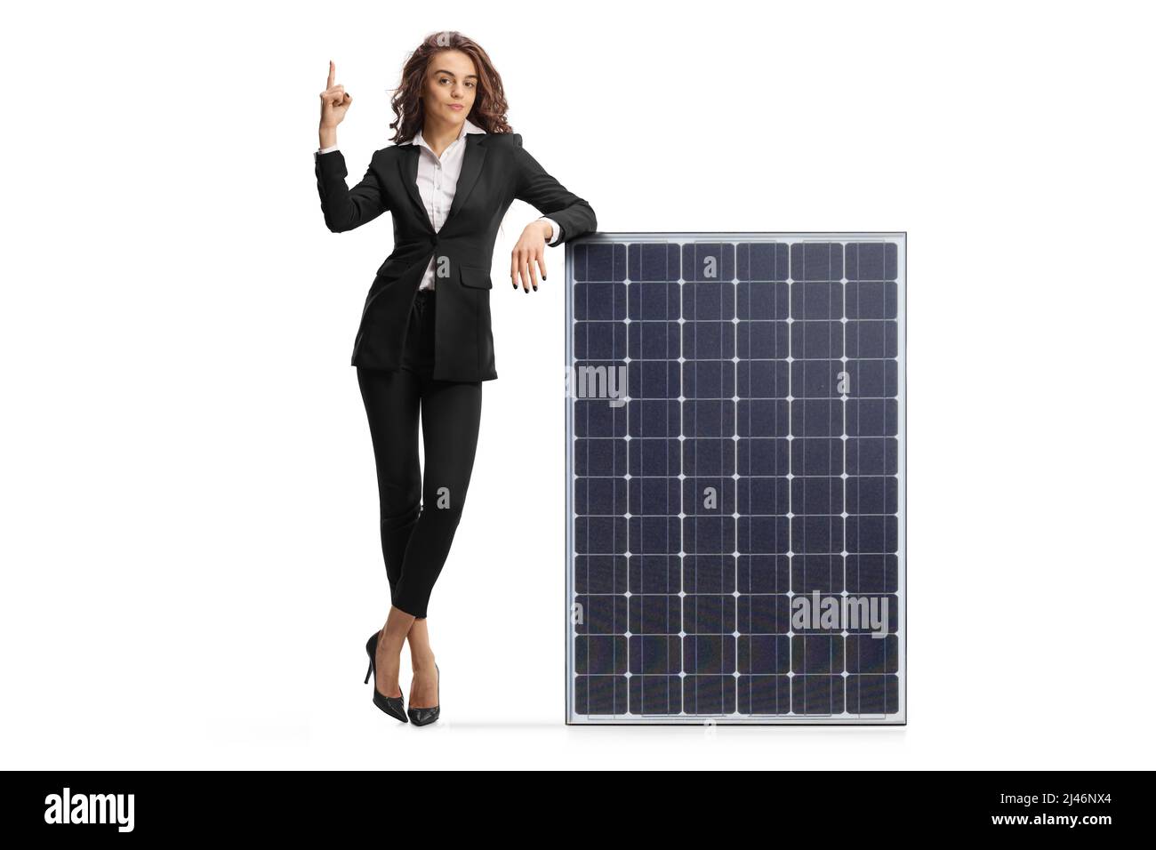 Full length portrait of a businesswoman leaning on a solar panel and ...