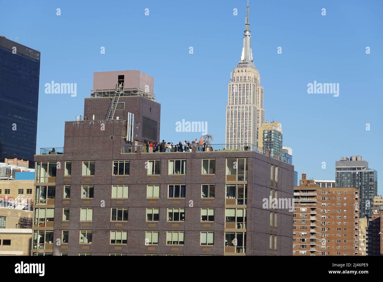 Roof top party New York with Empire State Building in background, New York USA Stock Photo