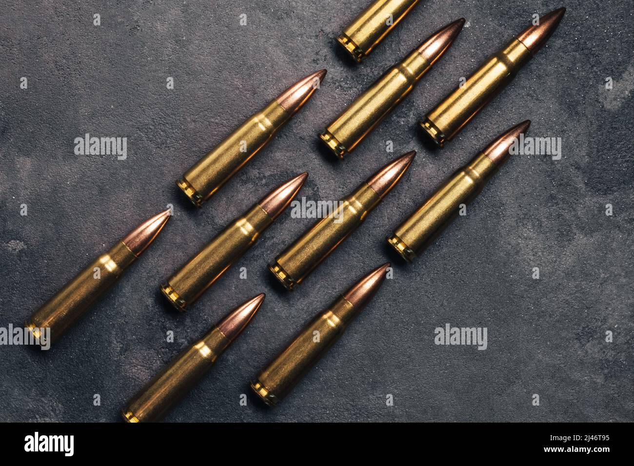 Bullets on gray background. Cartridges 7.62 caliber for Kalashnikov assault rifle. Top view, flat lay Stock Photo