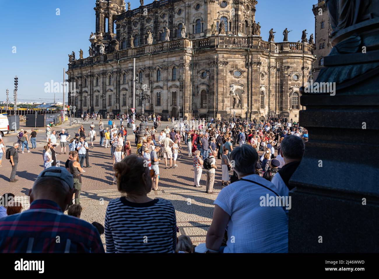 People on the Theaterplatz at an event. Historic architecture of the old town in the background. A famous place in the city. A high police presence. Stock Photo
