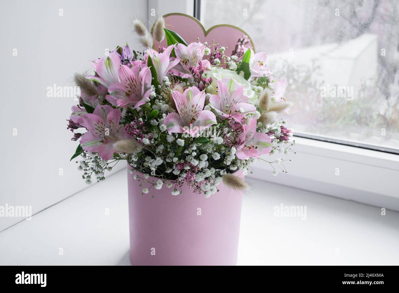 Delicate bouquet of pink lilies, white roses and gypsophila in a love ...