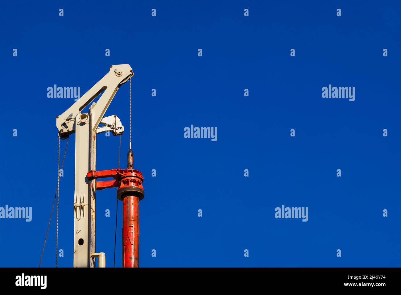 Construction industry. Pile driver at work (with copy space) Stock Photo