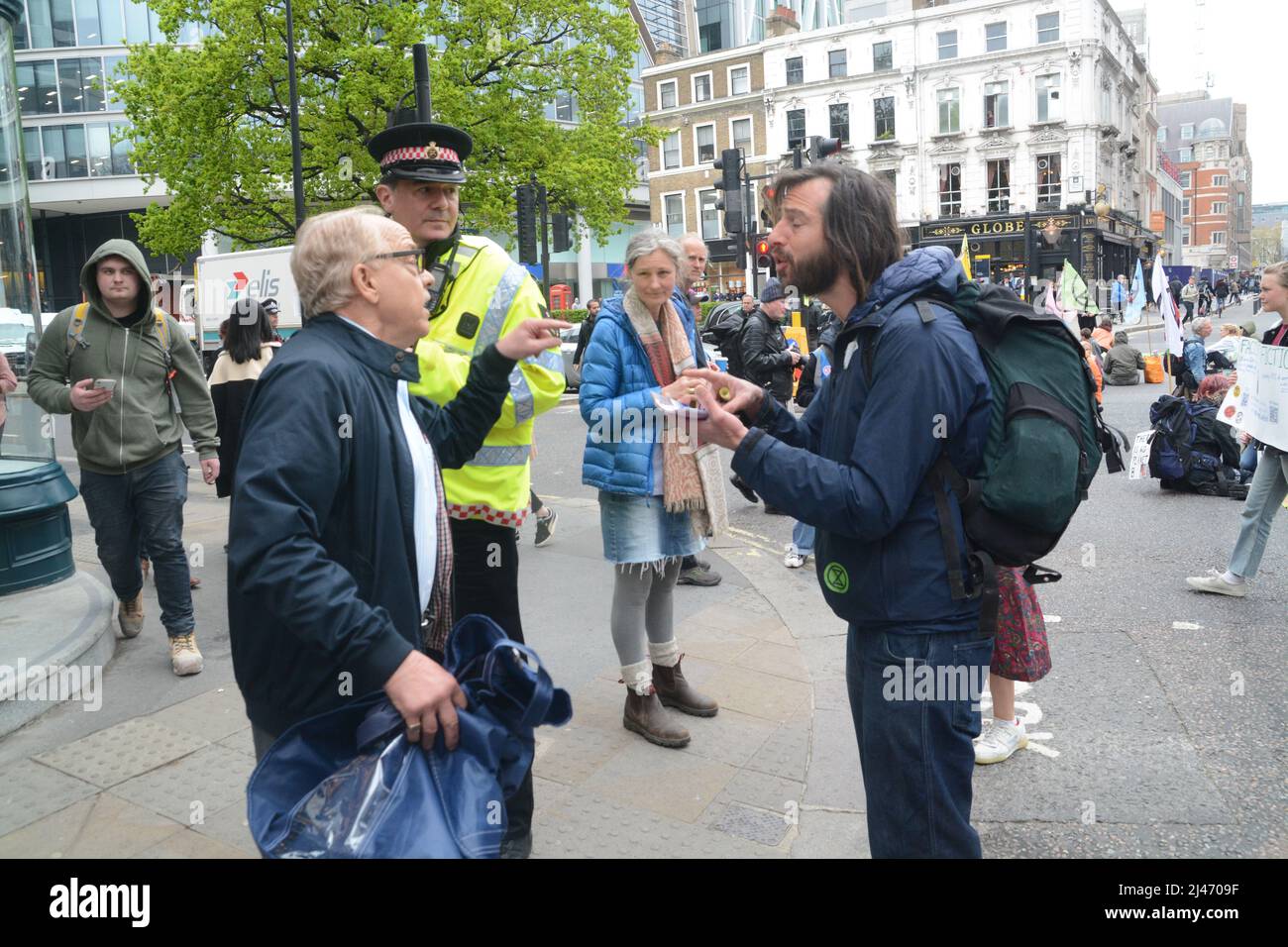 the climate activists xr  group took to the black rock hq following through to block london city roads one angered worker confronts the road block Stock Photo