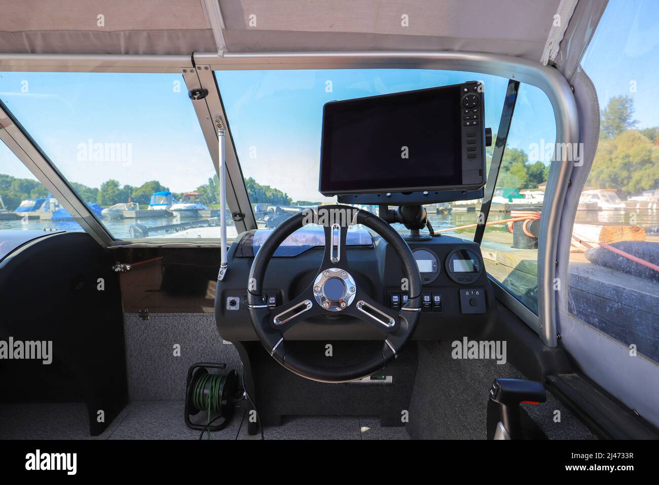 Motor boat steering wheel and dashboard with navigation devices Stock