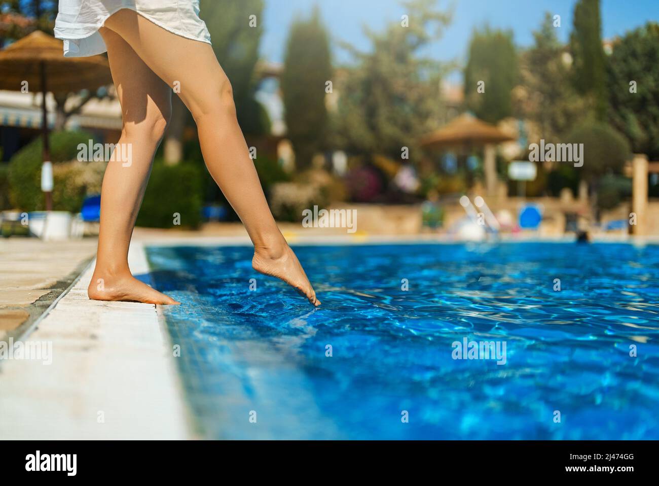 Woman with feet in swimming pool hi-res stock photography and images ...