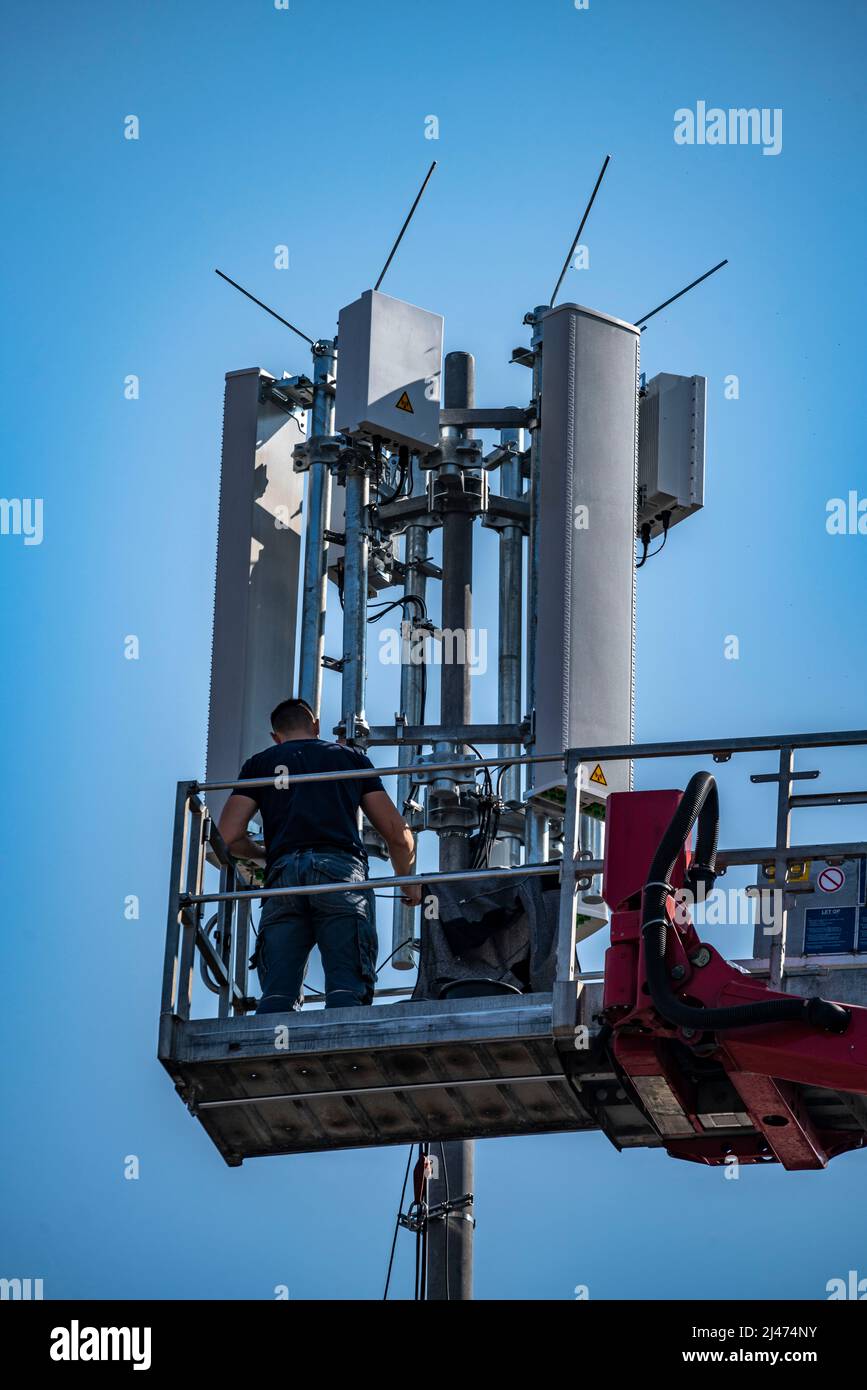 Assembly, installation of a 5G mobile radio transmitter, mast on a residential building, fast mobile internet, Düsseldorf, NRW, Germany Stock Photo