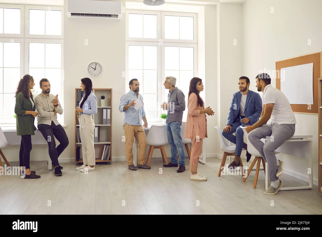 Groups of people gather in office during break at business conference or work meeting Stock Photo