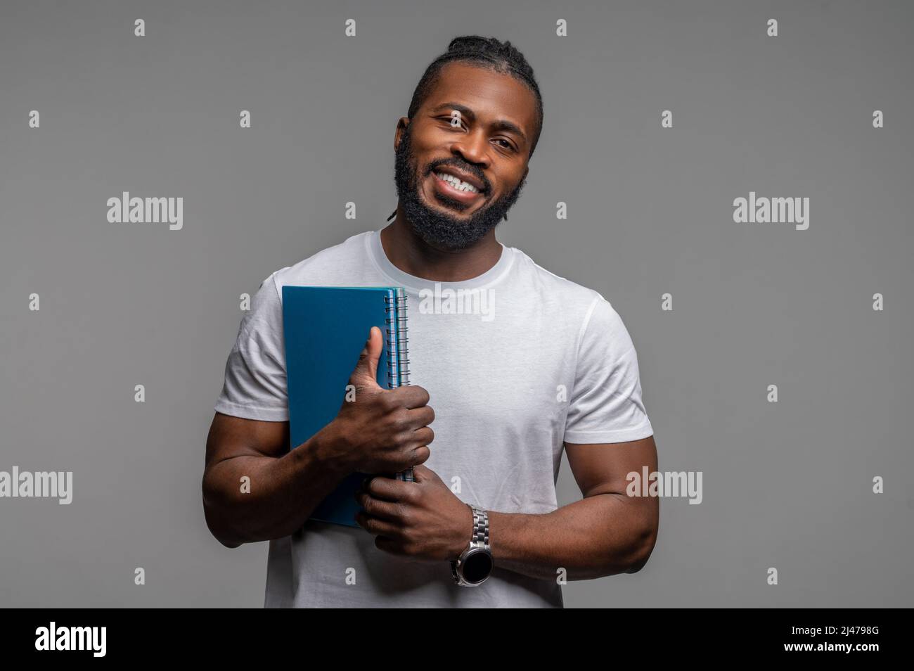 Cheerful male student posing for the camera Stock Photo