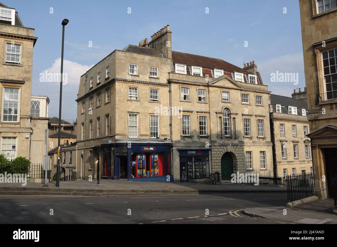 William Hill bookmakers shop, the corner of Lansdown road and Hay Hill in Bath England. Georgian architecture period properties. Bath stone buildings Stock Photo