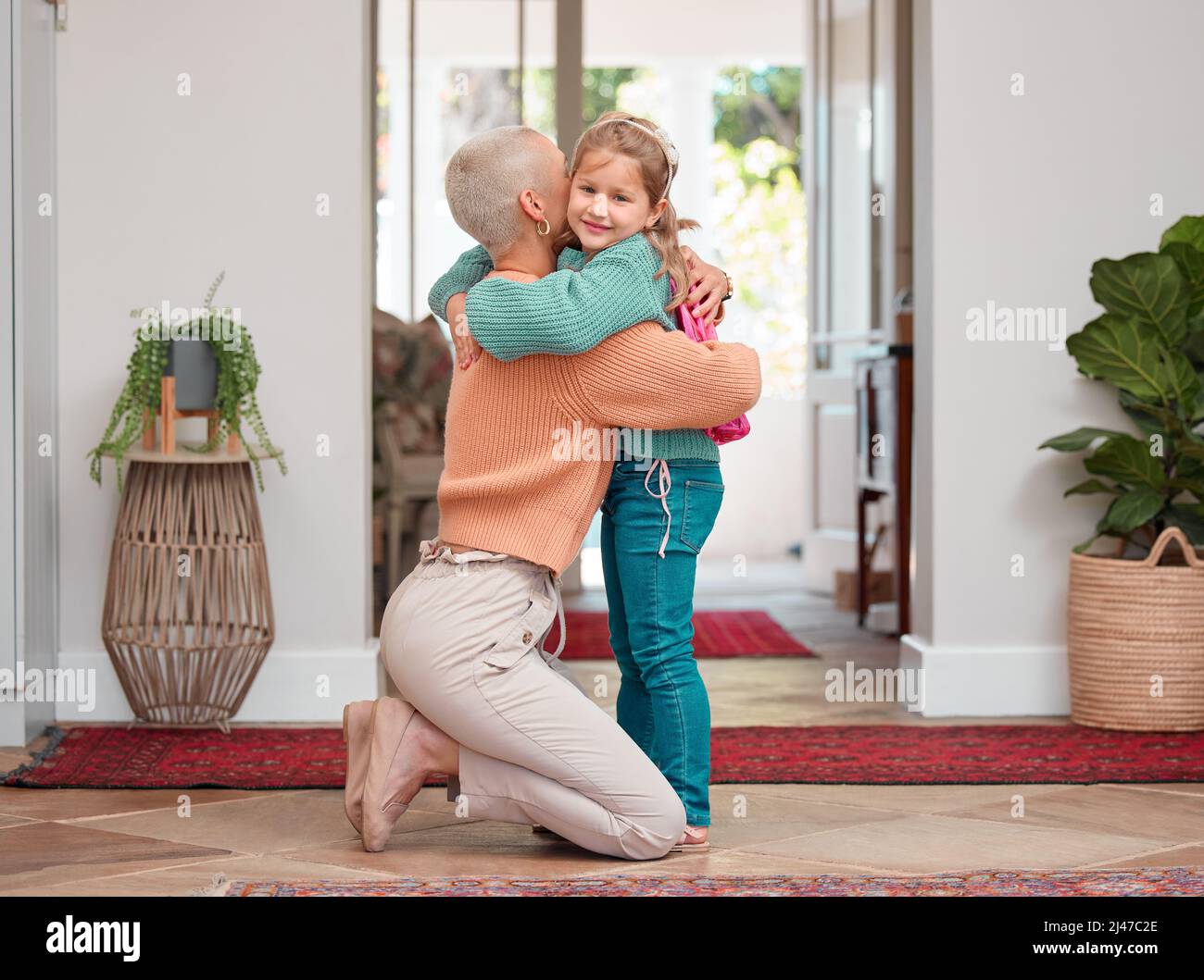I hope you have a good day. Shot of a woman seeing her daughter off before school. Stock Photo