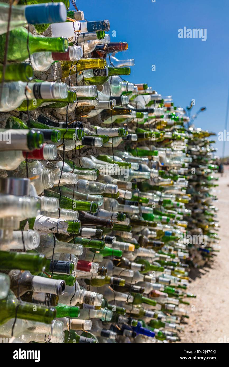 The East Jesus glass bottle wall made from glass wine bottles and others. The bottles are put in concrete. East Jesus is an experimental, sustainable Stock Photo
