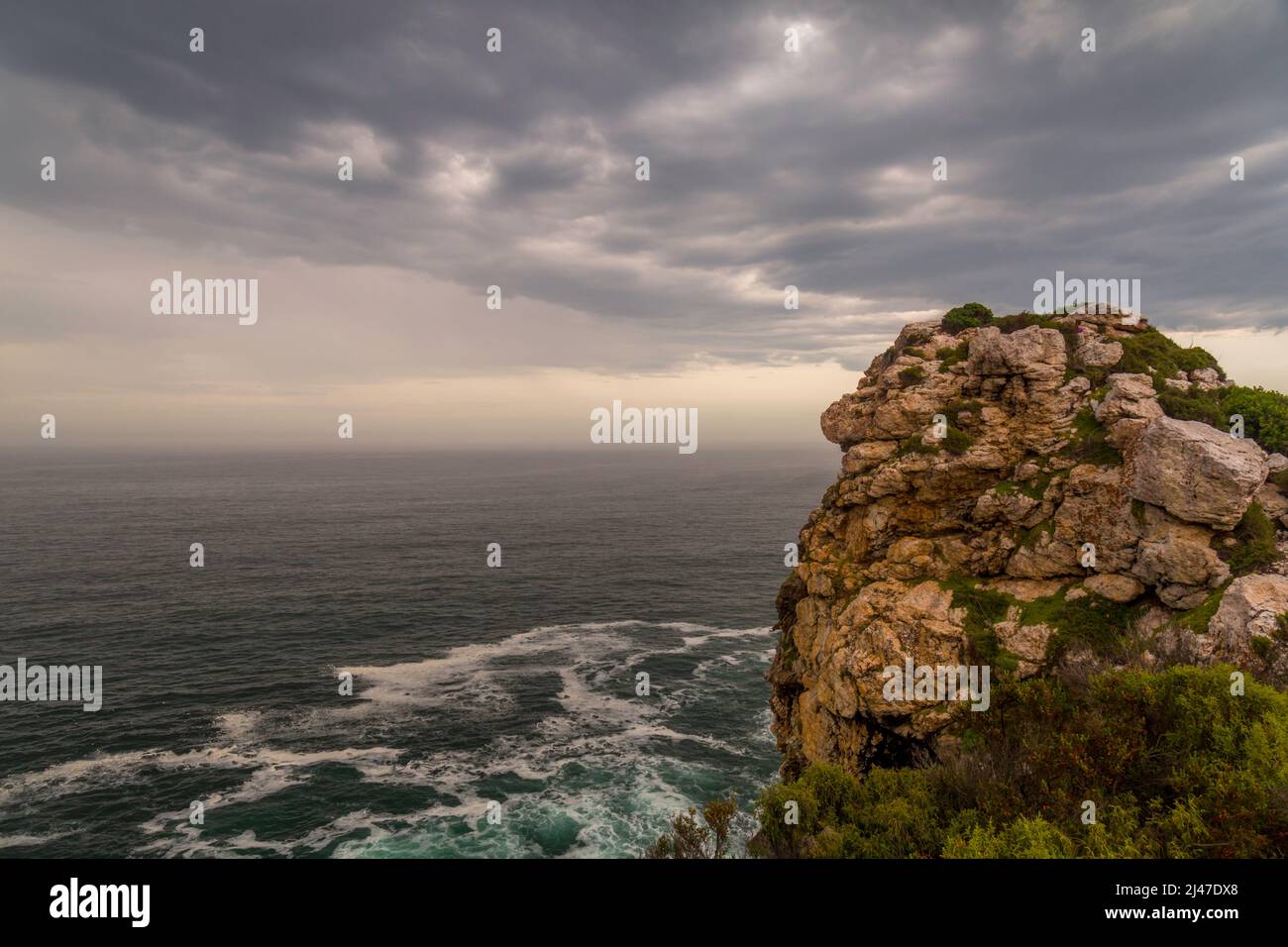 A rocky outcrop overlooking the ocean on The Otter Trail in the Western Cape of South Africa. Stock Photo