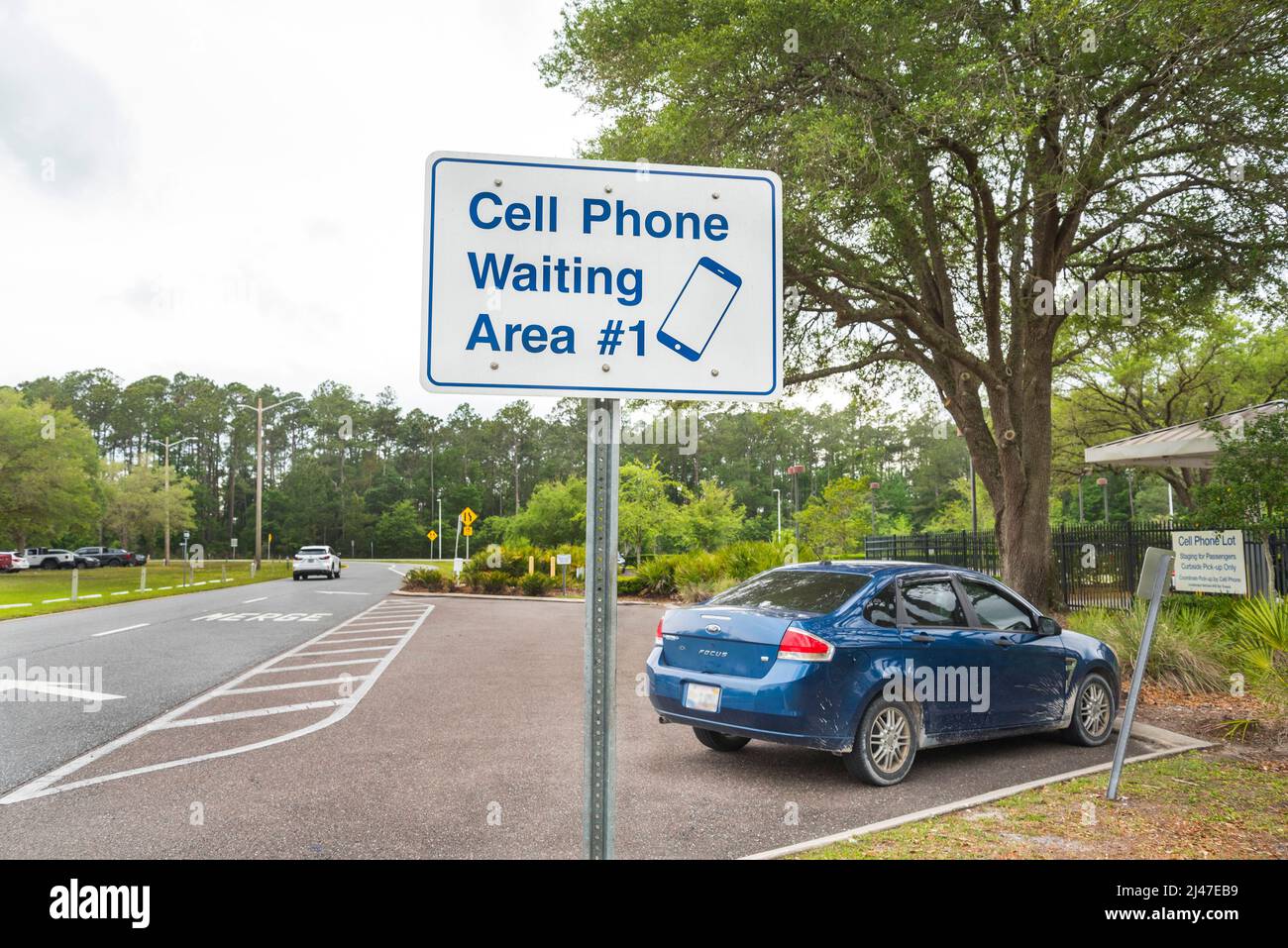 Cell phone parking area for vehicles waiting for passenger arrivals at