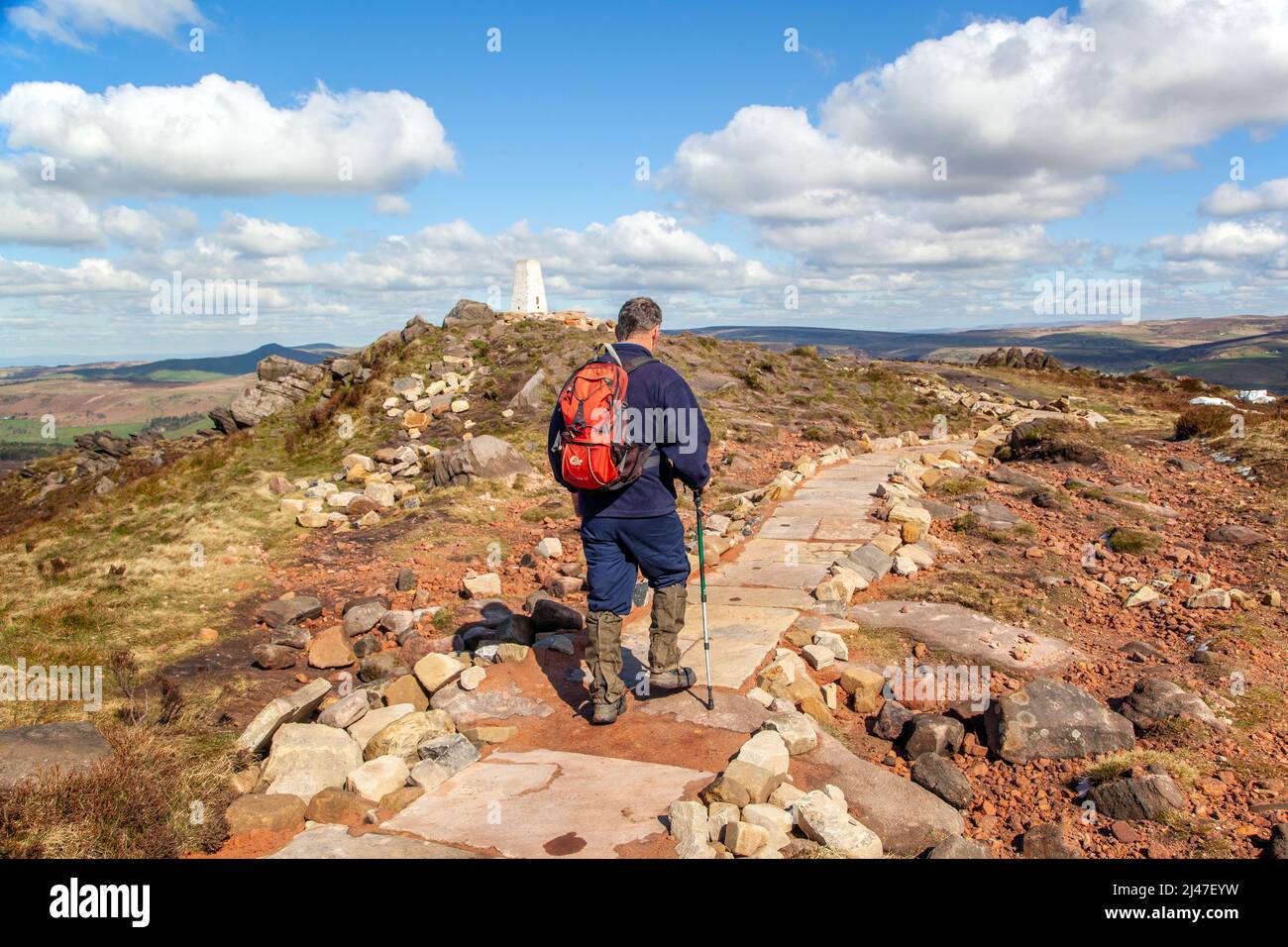 Man hill walking in the Peak District National park  on the Roaches range of rocks in the Staffordshire moorlands near Leek Staffordshire Stock Photo