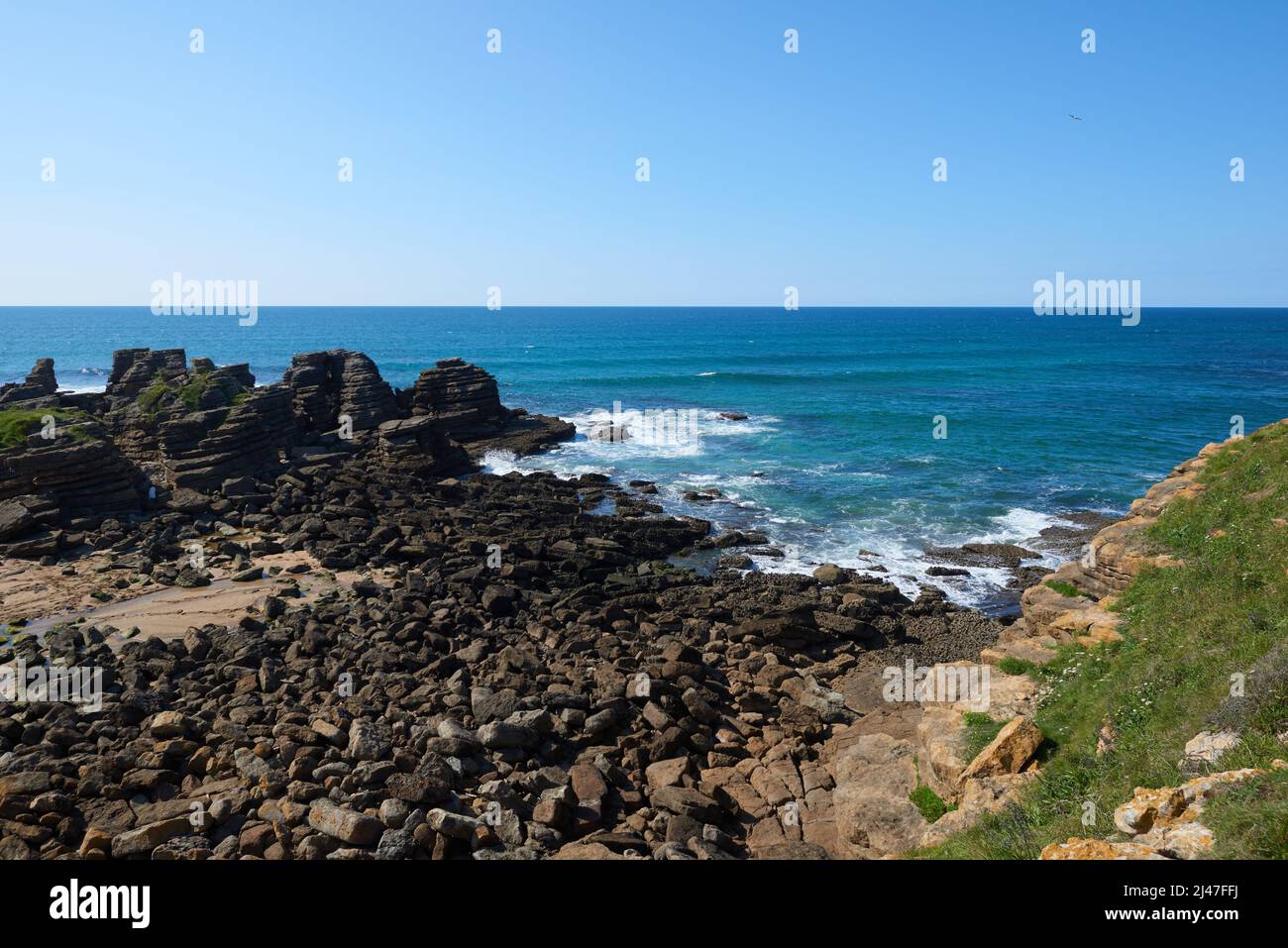 Steep cliffs with a deep blue sea and a clear blue sky Stock Photo - Alamy