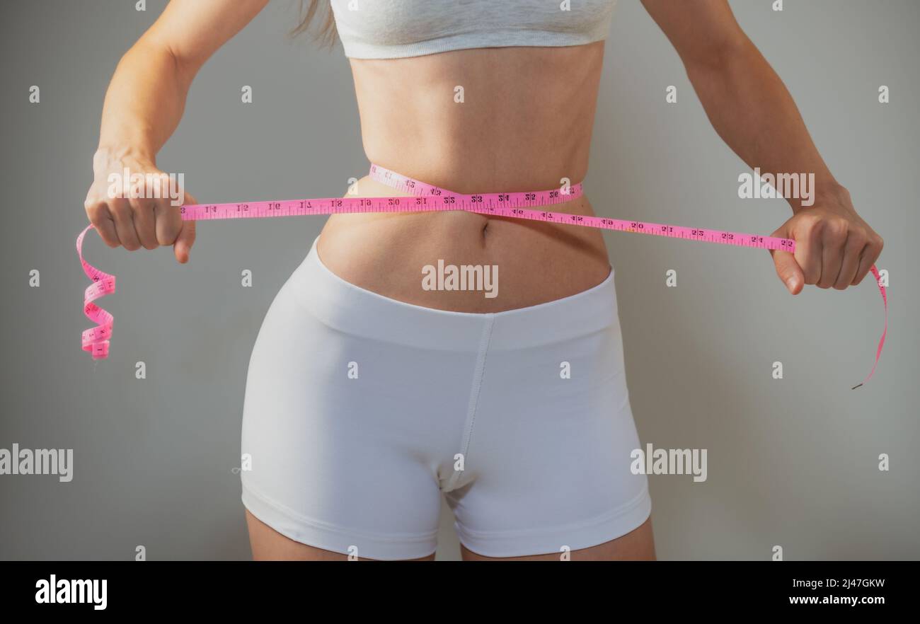 young girl belly waist measurement with tape measure and measure in  centimeters Stock Photo - Alamy