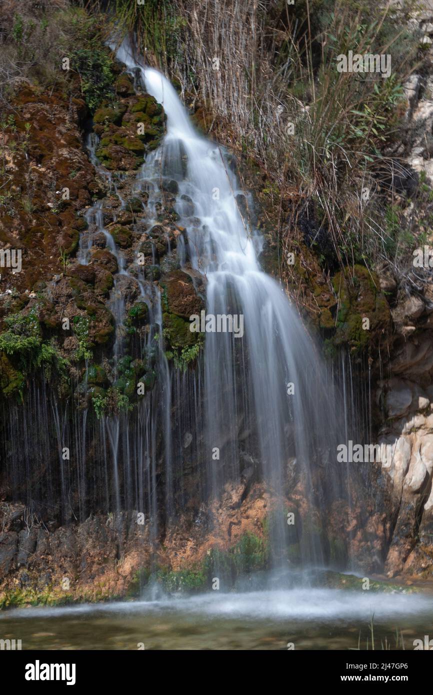 Smooth water a waterfall on ' rambla de puça' green way, Petrer, Elda, Alicante, Spain Stock Photo