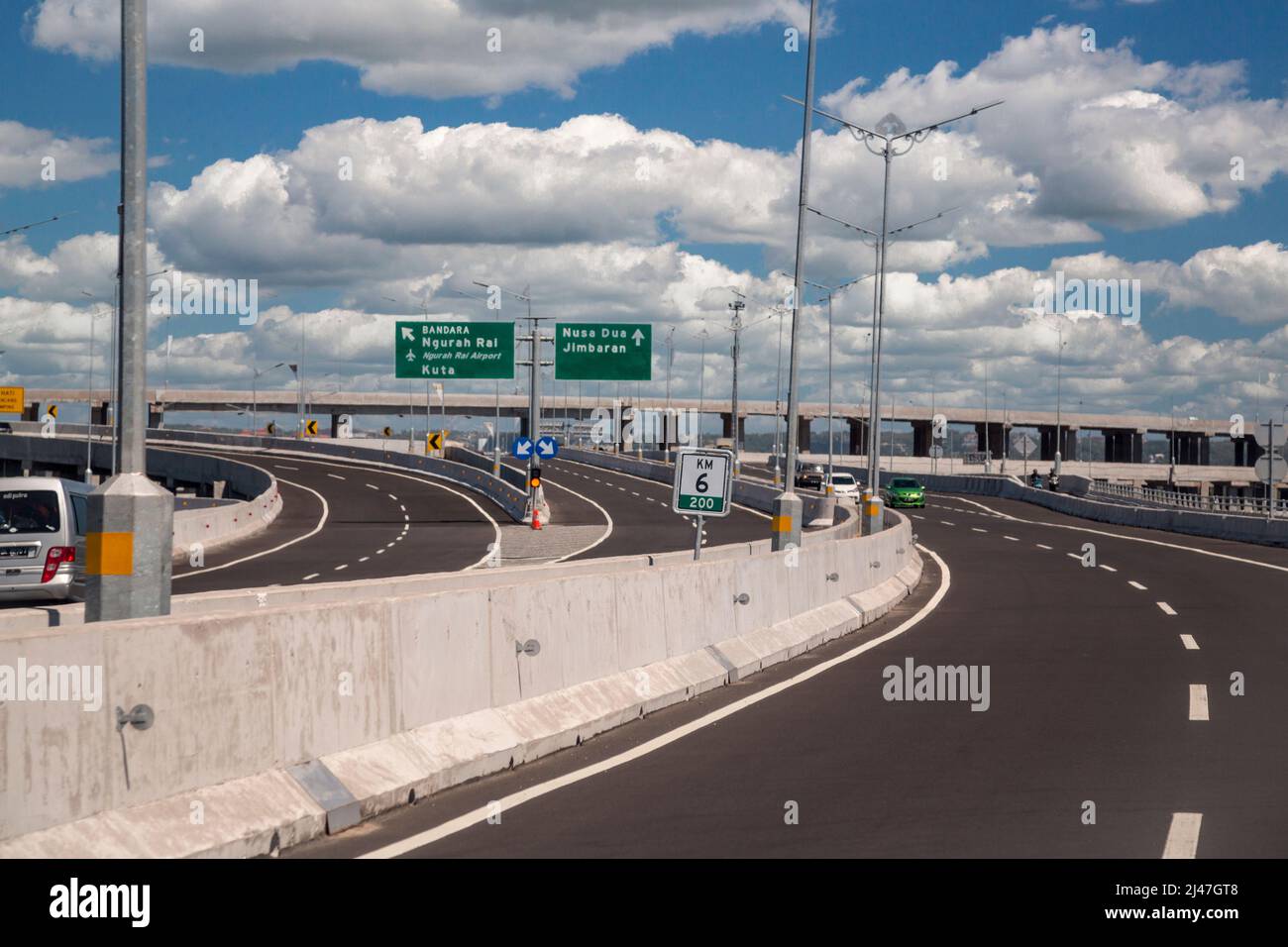 Bali, Indonesia.  Expressway, Super Highway, Modern Roadway.  Sign to Airport.  Driving on the Left. Stock Photo